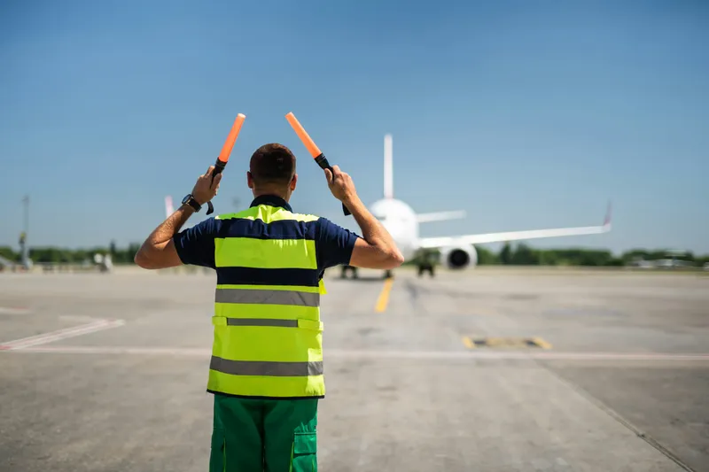 A dockside worker coordinating travel and deployment logistics